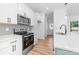 Updated kitchen features stainless steel appliances, white cabinets, and a stylish backsplash at 501 Ed Wilson Rd, Bessemer City, NC 28016