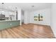 Open-concept living space with hardwood flooring, white walls, modern fixtures, and abundant natural light at 501 Ed Wilson Rd, Bessemer City, NC 28016