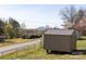 Exterior shot of storage shed at the edge of a grassy property at 501 Ed Wilson Rd, Bessemer City, NC 28016