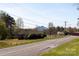 Street view of home with grassy yard and distant mountain at 501 Ed Wilson Rd, Bessemer City, NC 28016