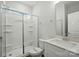 Clean bathroom featuring a shower with glass door, white cabinets and quartz counters at 5112 Heathland Dr # 75, Charlotte, NC 28215