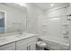 Bright bathroom features a double vanity, and a bathtub shower combo with white tiling at 5112 Heathland Dr # 75, Charlotte, NC 28215