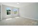 This bedroom has two windows to give a view of the neighborhood, and neutral colored carpet at 5112 Heathland Dr # 75, Charlotte, NC 28215