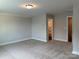 Neutral bedroom with walk-in closet and access to bathroom at 5112 Heathland Dr # 75, Charlotte, NC 28215