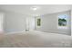 Spacious bedroom with neutral carpet, large windows, and base molding at 5112 Heathland Dr # 75, Charlotte, NC 28215