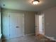 Bedroom featuring neutral carpet, closet, and access to another room at 5112 Heathland Dr # 75, Charlotte, NC 28215