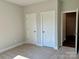 Bedroom with neutral carpet, grey walls, and white doors at 5112 Heathland Dr # 75, Charlotte, NC 28215