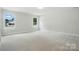 Spacious bedroom with neutral carpet and two large windows allowing plenty of natural light at 5112 Heathland Dr # 75, Charlotte, NC 28215