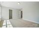 The bedroom features an open doorway and is illuminated by a flush mount light fixture at 5112 Heathland Dr # 75, Charlotte, NC 28215