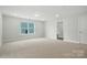 Spacious bedroom with neutral carpet, large window, recessed lighting, and attached closet at 5112 Heathland Dr # 75, Charlotte, NC 28215