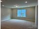 Spacious bonus room featuring neutral carpet and a window with blinds at 5112 Heathland Dr # 75, Charlotte, NC 28215