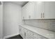 Elegant butler's pantry featuring white cabinetry, countertops, subway tile backsplash, and plenty of storage at 5112 Heathland Dr # 75, Charlotte, NC 28215