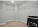 Walk-in closet with wire shelving and neutral carpeting offers ample storage space at 5112 Heathland Dr # 75, Charlotte, NC 28215