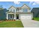 Charming two-story home with a well-manicured lawn and a two car garage at 5112 Heathland Dr # 75, Charlotte, NC 28215