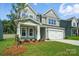 Traditional two-story home with a manicured front lawn and a two-car garage at 5112 Heathland Dr # 75, Charlotte, NC 28215