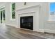 Bright living room with a modern fireplace featuring a decorative white mantel and marble surround at 5112 Heathland Dr # 75, Charlotte, NC 28215