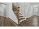 Spacious foyer with wood stairs, modern railings, and wood-look floors at 5112 Heathland Dr # 75, Charlotte, NC 28215