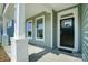 Inviting front porch with classic white columns and a black front door at 5112 Heathland Dr # 75, Charlotte, NC 28215