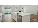Spacious kitchen with a center island, stainless steel dishwasher, and views of a landscaped backyard at 5112 Heathland Dr # 75, Charlotte, NC 28215