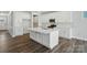 A modern kitchen is showcased with white cabinetry, stainless steel appliances, and a large central island at 5112 Heathland Dr # 75, Charlotte, NC 28215