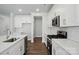 Well-lit kitchen featuring an island with stainless steel appliances, white cabinets, and subway tile backsplash at 5112 Heathland Dr # 75, Charlotte, NC 28215