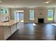 Bright living room with fireplace, wood floors, and sliding door access to the backyard at 5112 Heathland Dr # 75, Charlotte, NC 28215