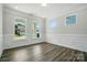 Empty room with hardwood floors, white walls, trim and plenty of natural light at 5112 Heathland Dr # 75, Charlotte, NC 28215