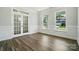 Empty room with hardwood floors, white walls, trim and lots of natural light at 5112 Heathland Dr # 75, Charlotte, NC 28215