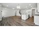 Expansive living room blends seamlessly into a modern kitchen, with a staircase visible in the background at 5112 Heathland Dr # 75, Charlotte, NC 28215