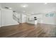 Spacious living area with hardwood floors, leading to a modern kitchen at 5112 Heathland Dr # 75, Charlotte, NC 28215