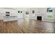 Open floor plan: living room with fireplace, adjacent to a modern white kitchen at 5112 Heathland Dr # 75, Charlotte, NC 28215