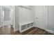 Bright mudroom features a built-in bench with storage and coat hooks at 5112 Heathland Dr # 75, Charlotte, NC 28215