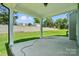 Covered patio offers an outdoor space with a view of the backyard and retaining wall at 5112 Heathland Dr # 75, Charlotte, NC 28215