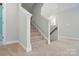 Carpeted stairway with white trim and grey walls leads to the upper level of the home at 5112 Heathland Dr # 75, Charlotte, NC 28215