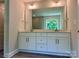 Elegant bathroom featuring double sinks, ample counter space and modern vanity at 5115 Heathland Dr # 47, Charlotte, NC 28215