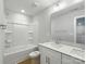 Bathroom with double vanity, bath and shower combo with neutral color palette at 5115 Heathland Dr # 47, Charlotte, NC 28215