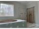 Bathroom with a modern tub and large window at 5115 Heathland Dr # 47, Charlotte, NC 28215
