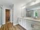A bathroom with a double vanity, hard wood floors, and a walk-in shower at 5115 Heathland Dr # 47, Charlotte, NC 28215