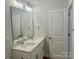 Bathroom with a double sink vanity with quartz countertops and contemporary fixtures at 5115 Heathland Dr # 47, Charlotte, NC 28215