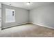 Bedroom with neutral carpet, paint, and one window at 5115 Heathland Dr # 47, Charlotte, NC 28215