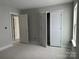 Spacious bedroom with a window and multiple doorways, offering ample space and convenient access to other areas at 5115 Heathland Dr # 47, Charlotte, NC 28215