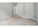 An empty bedroom with neutral paint, carpet, and two white doors at 5115 Heathland Dr # 47, Charlotte, NC 28215