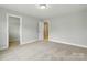 Bedroom featuring neutral carpet and paint with doorways to a closet and the hallway at 5115 Heathland Dr # 47, Charlotte, NC 28215