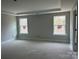 Spacious primary bedroom with two windows and ample natural light at 5115 Heathland Dr # 47, Charlotte, NC 28215