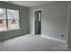 Bright bedroom with a large window and neutral walls, creating a serene and inviting space at 5115 Heathland Dr # 47, Charlotte, NC 28215