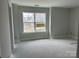 Well-lit bedroom with neutral paint, large windows, and bright natural light, ready for personalization at 5115 Heathland Dr # 47, Charlotte, NC 28215