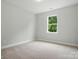 Bedroom with carpet, neutral walls and base trim, freshly painted in move-in ready condition at 5115 Heathland Dr # 47, Charlotte, NC 28215