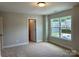 Bright bedroom with a large window offering natural light and neutral colored walls at 5115 Heathland Dr # 47, Charlotte, NC 28215