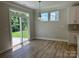 Bright breakfast nook featuring a sliding glass door, hardwood floors, and modern lighting at 5115 Heathland Dr # 47, Charlotte, NC 28215