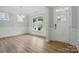Bright dining room features hardwood floors, elegant wainscoting, and natural light from large windows at 5115 Heathland Dr # 47, Charlotte, NC 28215